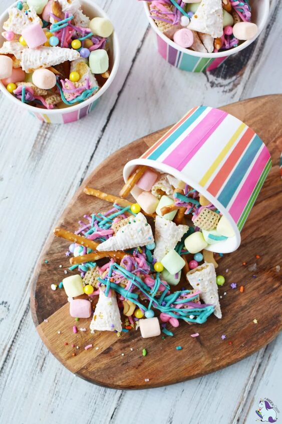 unicorn party snack mix, Unicorn party snack mix spilling out of striped paper cup on cutting board