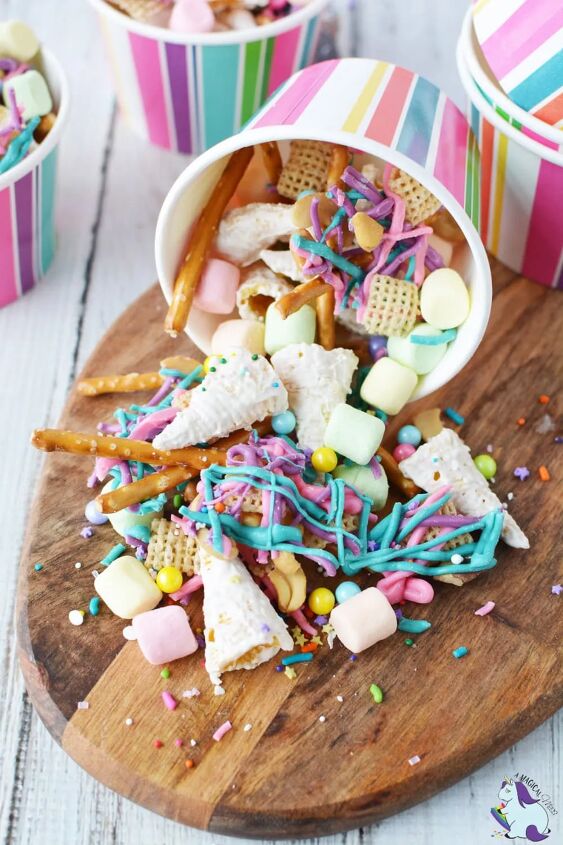 unicorn party snack mix, colorful unicorn snack mix spilling out of striped paper cup