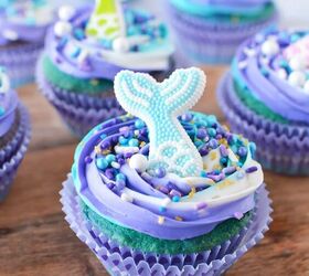 swirly blue and purple mermaid cupcakes, Mermaid cupcake sitting on a board with more cupcakes in the background