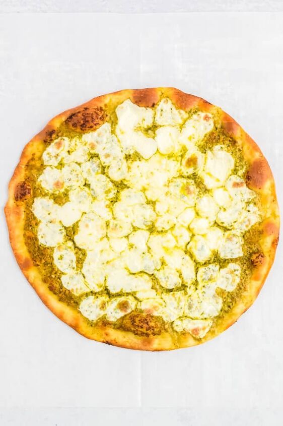 easy bruschetta pizza recipe, Pizza dough after it has been baked with the pesto and cheese
