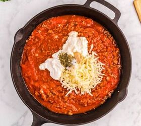 cast iron skillet lasagna, Meat and sauce with cheese and spices in a cast iron skillet