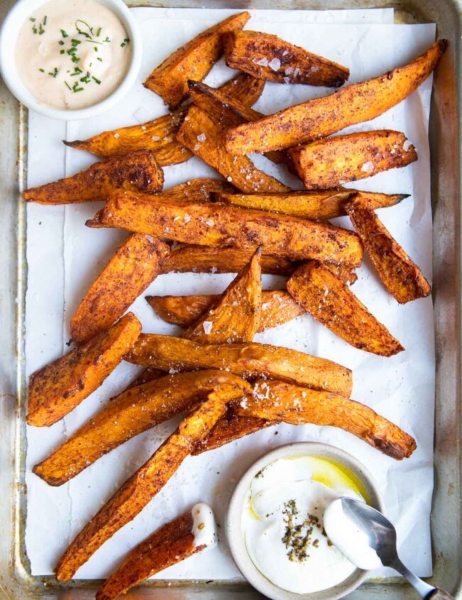 air fryer sweet potato wedges, cooked sweet potato wedges on a platter sprinkled with salt parmesan cheese and seasoning mix