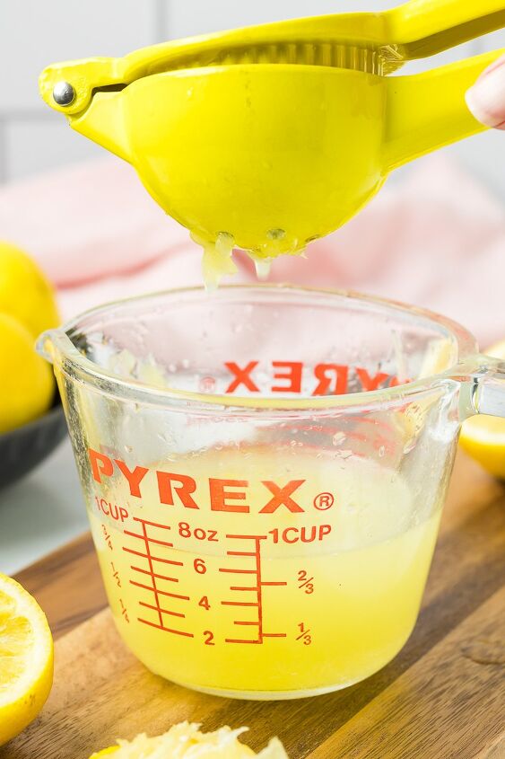 fresh squeezed lemonade, Lemon juice being squeezed into a measuring cup