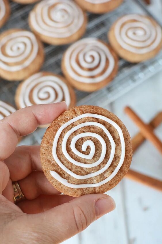 chewy cinnamon roll cookies with icing swirl, Holding a cinnamon roll cookie to show the detail