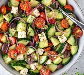 easy greek cucumber salad with feta, A bowl of Greek cucumber salad with a spoon