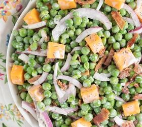 how to make classic pea salad, up close view of pea salad with creamy dressing cheddar cheese chunks onion slivers and chopped bacon