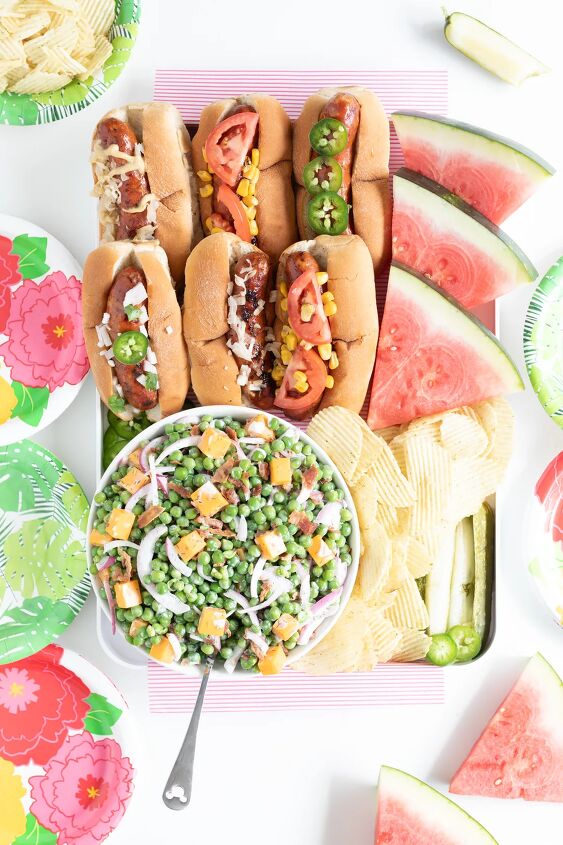 how to make classic pea salad, grilled sausage charcuterie board with pea salad grilled sausages served in buns chips watermelon slices and pickles