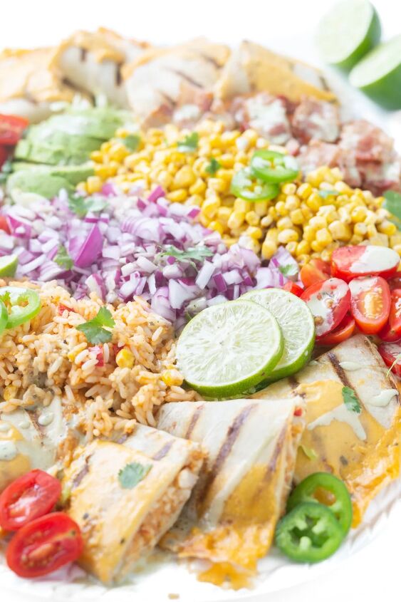 this family style quesadilla salad is better than restaurant versions, close up of mexican inspired salad with chopped onions sliced limes quesadillas halved grape tomatoes lime