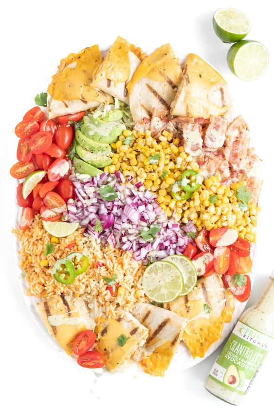 this family style quesadilla salad is better than restaurant versions, vibrant mexican salad with dressing drizzled all over it