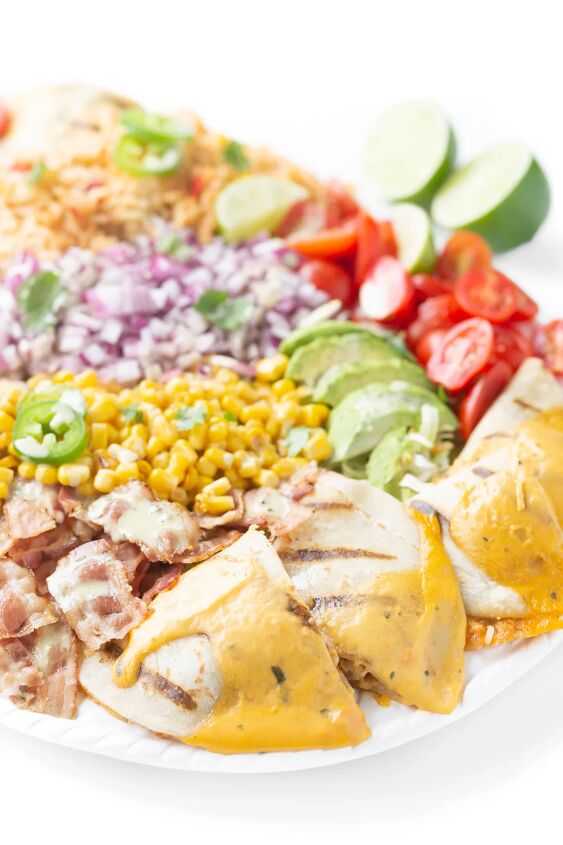 this family style quesadilla salad is better than restaurant versions, mexican inspired salad tray with mexican rice quesadillas with cheesy sauce bacon grape tomatoes fresh avocado slices diced onions