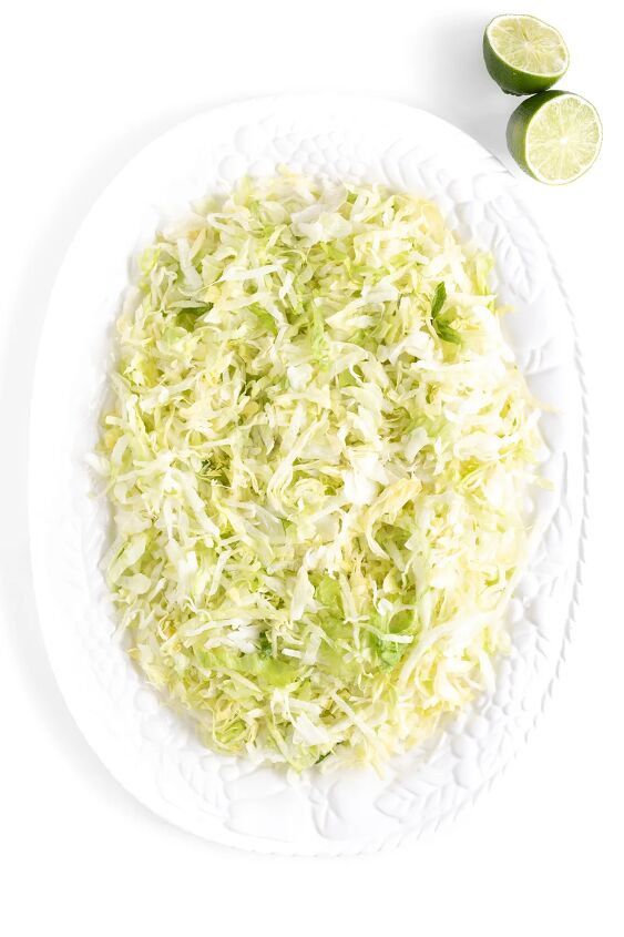 this family style quesadilla salad is better than restaurant versions, large serving platter with shredded lettuce in preparation of making a full salad
