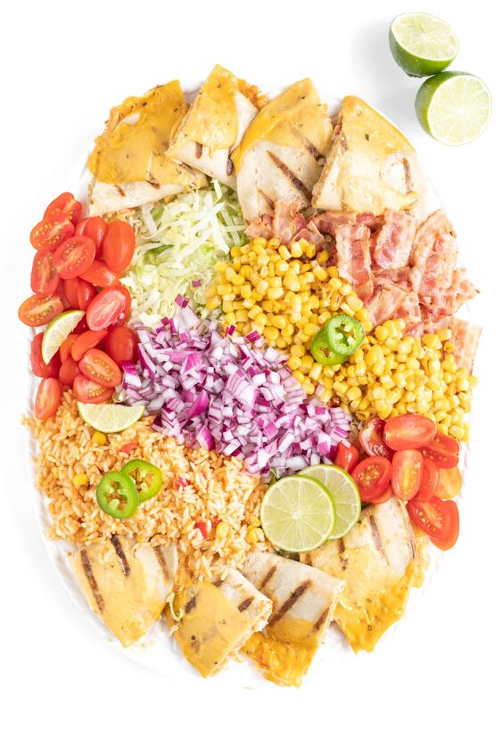this family style quesadilla salad is better than restaurant versions, garnishes added to salad jalapeno slices and lime slices and lime wedges
