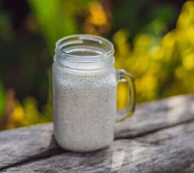 Healthy layered dessert with chia pudding in a mason jar on rustic background
