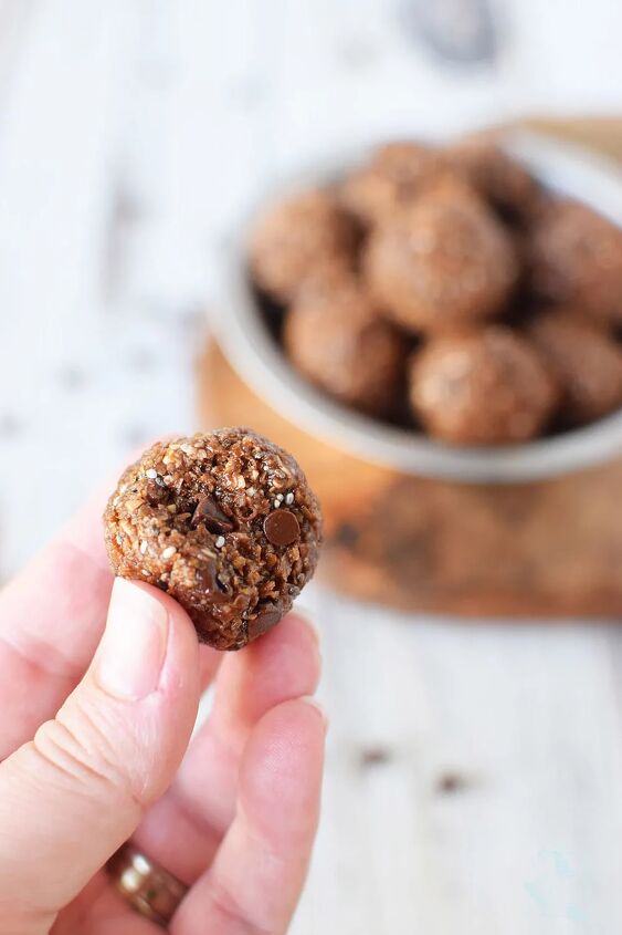 double chocolate energy balls recipe, Holding a chocolate energy ball with a bite taken out of it