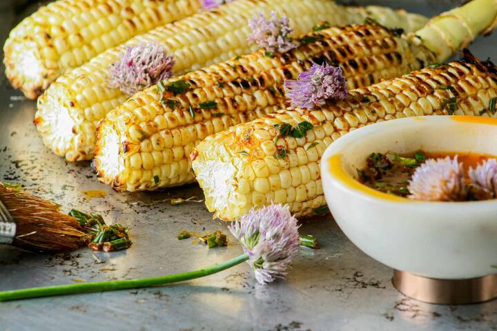 grilled corn with herbed chili butter, Grilled corn on the cob with herbed garlic butter Photographed on a metal baking tray