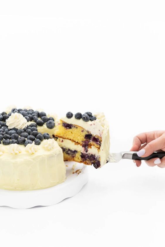 easy blueberry cake with whipped lemon frosting, Cutting a slice of cake to serve