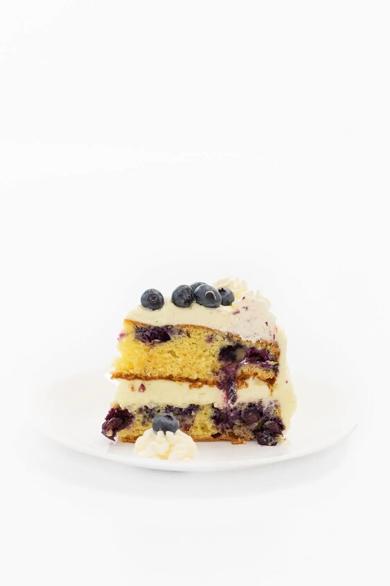 easy blueberry cake with whipped lemon frosting, Tall slice of blueberry cake with fresh blueberries
