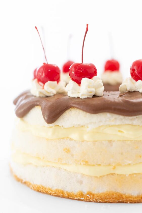 easy layered boston cream pie, Giant maraschino cherries o top of layered boston cream cake