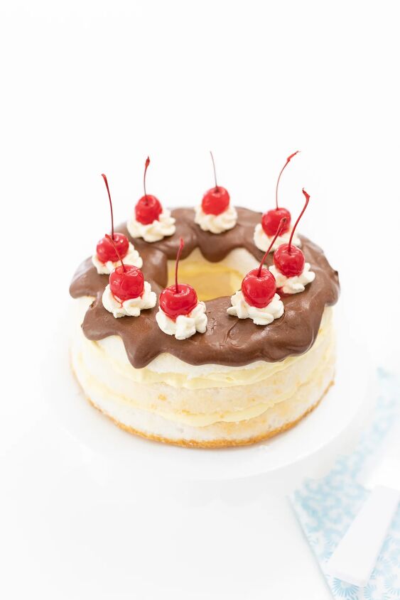 easy layered boston cream pie, pretty chocolate covered cake with layers of pudding and topped with pretty cherries