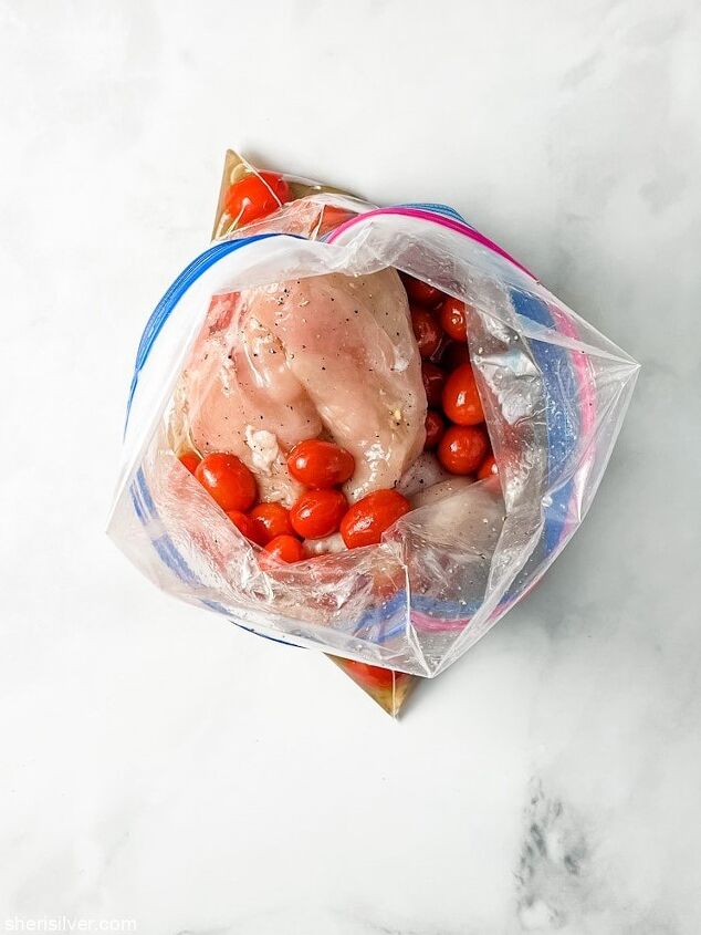 easy one pan basil halloumi chicken, chicken and tomatoes in a ziploc bag