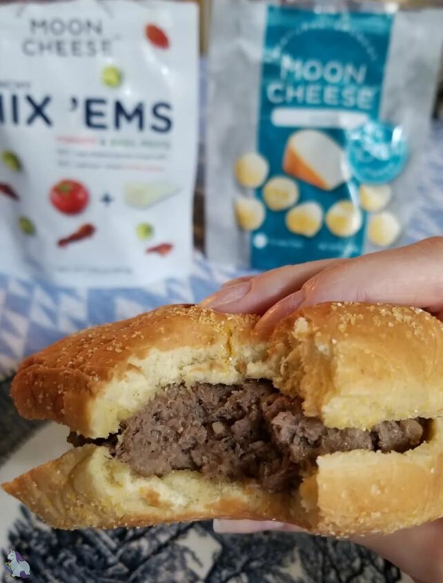 sneaky cheeseburger recipe, Holding a burger with a bite taken out of it