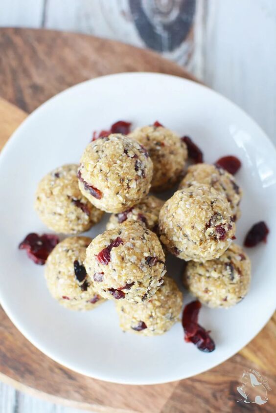 cranberry no bake energy bites recipe, No bake energy balls with cranberry on a white plate