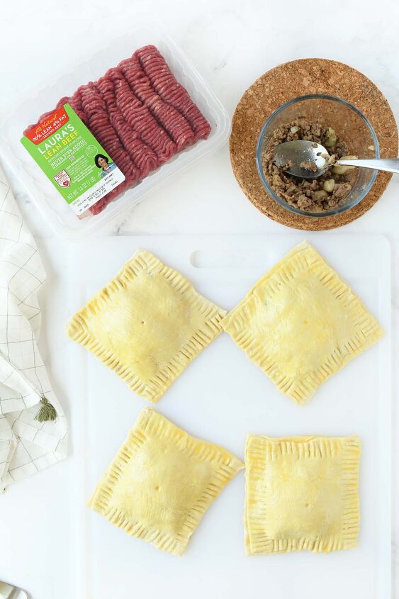 easy cheesy beef onion potato puff pastry pockets, Puff pastry squares on a white table