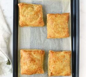 easy cheesy beef onion potato puff pastry pockets, Golden brown puff pastry pockets on a blue baking sheet
