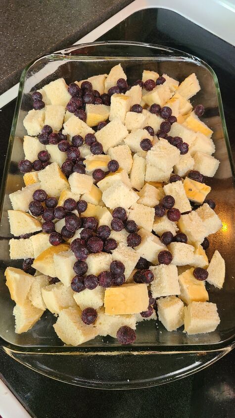 blueberry french toast casserole recipe, A casserole dish filled with bread cubes and frozen blueberries