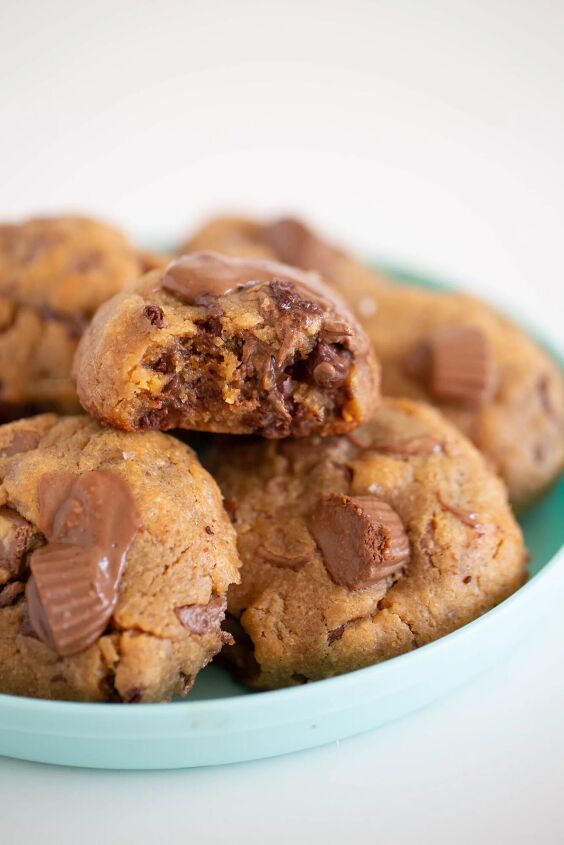 the peanut butter cup cookies recipe you ll make again and again, side view of a plate stacked with peanut butter cup cookies