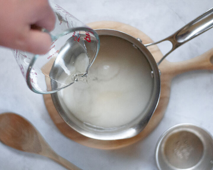 simple syrup, Pouring water into a saucepan with sugar preparing to make homemade simple syrup