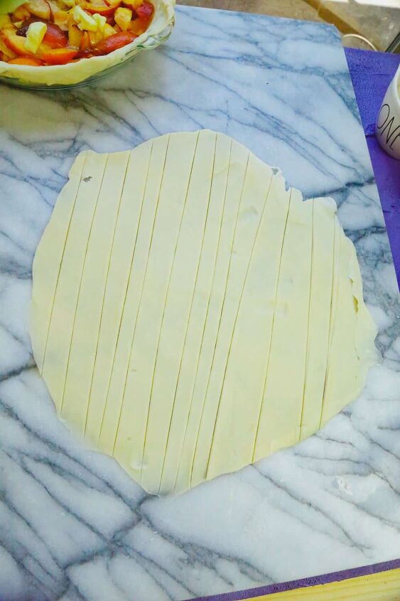 honey peach pie homemade, strips of pie crust cut into 1 inch strips to make a lattice topping pie crust