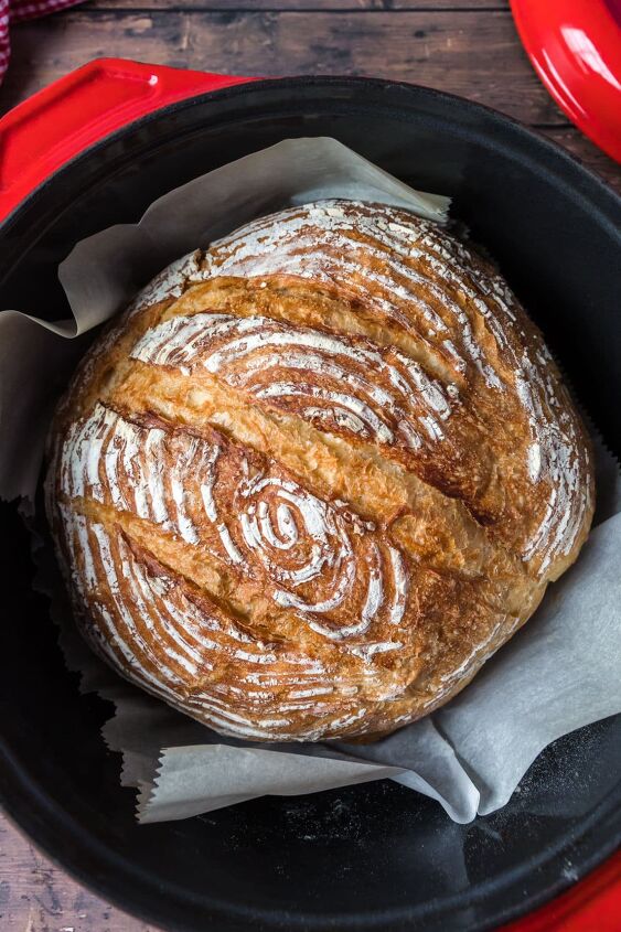 how to make dutch oven sourdough bread, Round golden brown artisan sourdough bread baked in a red dutch oven