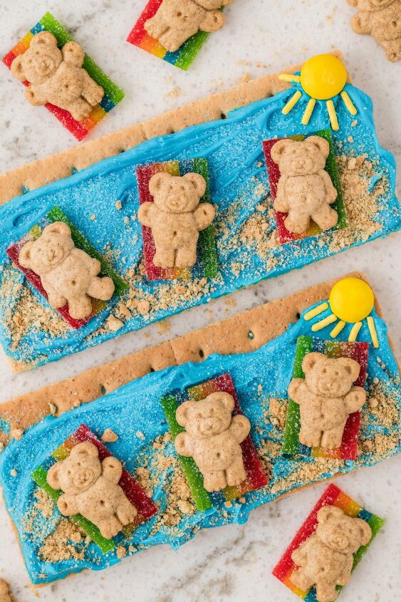 how to make beach day graham crackers, up close over the top view of beach themed graham crackers with teddy grahams and a candy sun cute kid snack