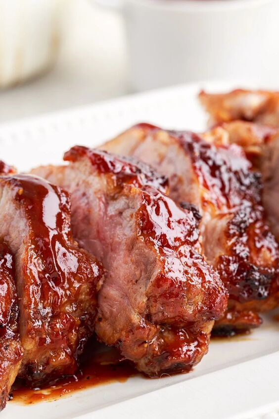 the 20 minute air fryer ribs you ll be craving, side view of barbecued ribs on a white plate