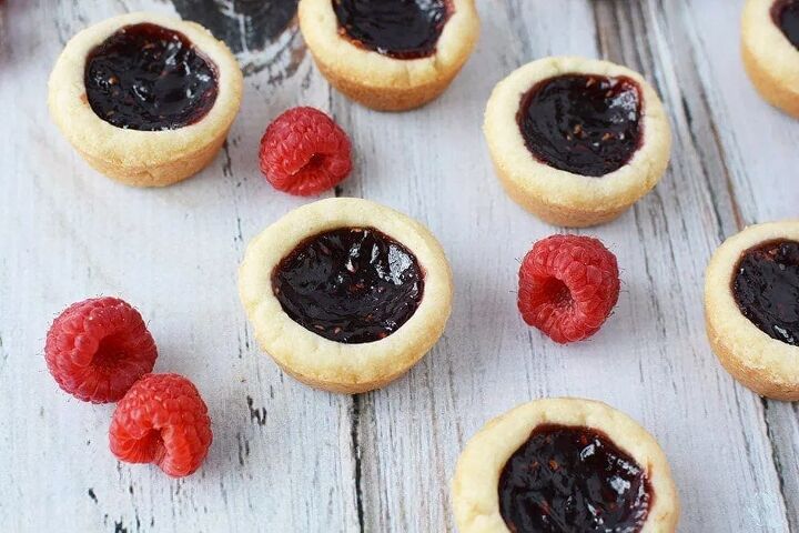 easy raspberry tarts recipe bite sized buttery crunch, Raspberry tarts on a table with raspberries