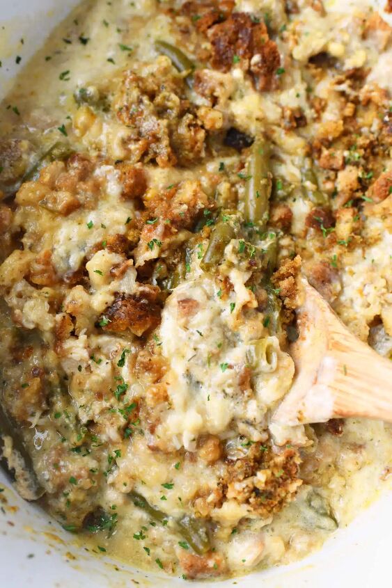 the best slow cooker chicken and stuffing, Golden brown chicken and stuffing on a wooden spoon
