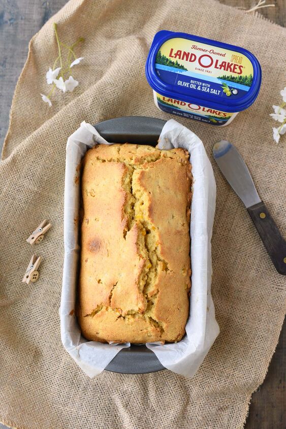 perfectly moist and sweet cornbread with real corn, A golden brown cornbread loaf with a tub of butter