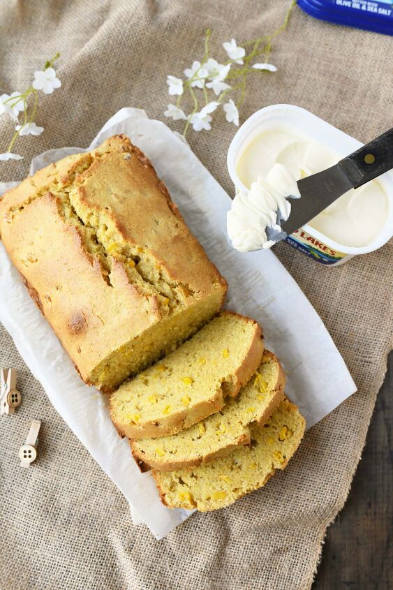 perfectly moist and sweet cornbread with real corn, Sliced cornbread loaf with butter on a spatula