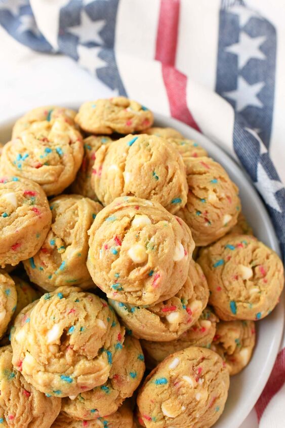 red white and blue sprinkle pudding cookies, A white plate of chewy pudding cookies with a flag napkin