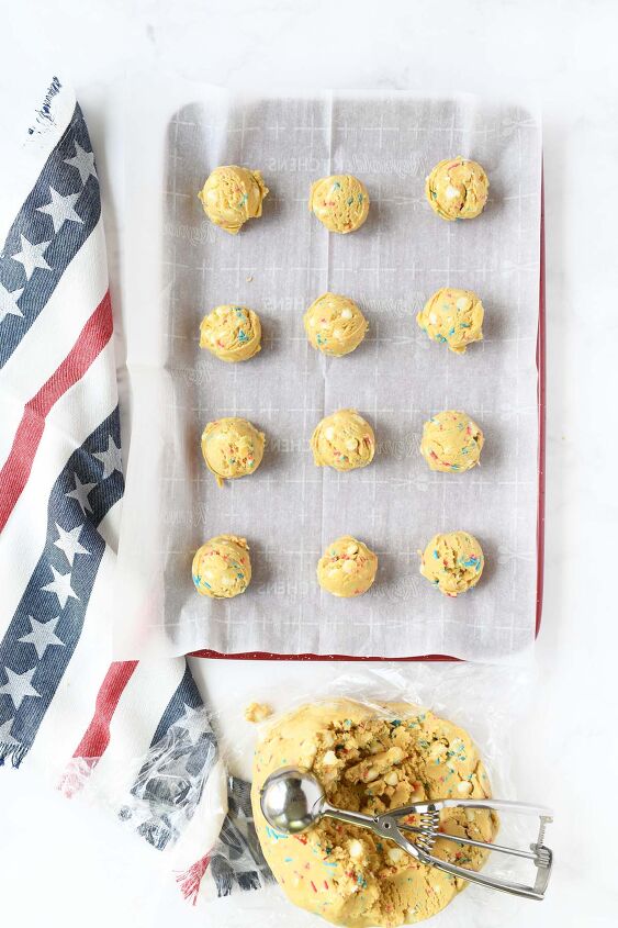 red white and blue sprinkle pudding cookies, Unbaked cookie dough balls on a red baking sheet