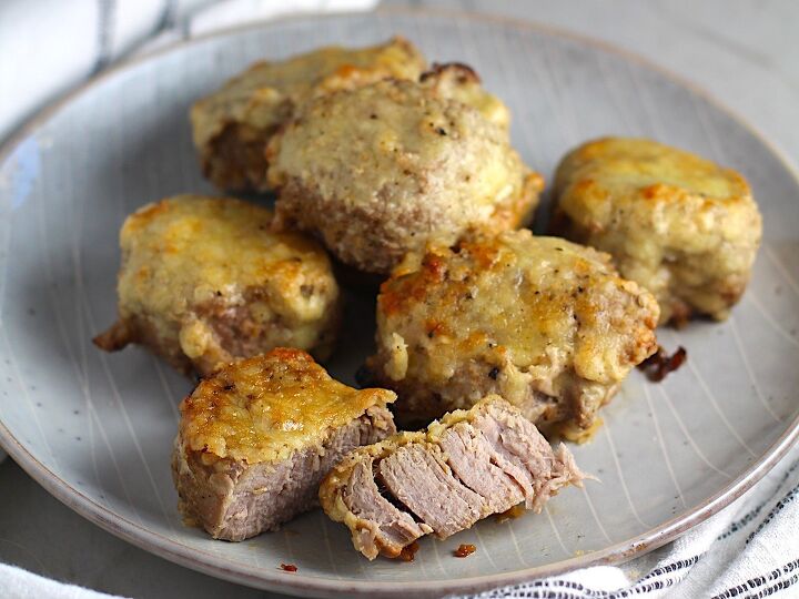 crusted parmesan pork tenderloin, Parmesan Pork Tenderloin pieces on a plate with one cut in half They are juicy salty and slightly cheesy It s easy to make in the oven so you can enjoy it at home anytime