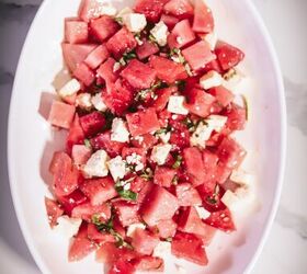 watermelon basil salad with feta, Spreading the salad on a platter drizzling with oil and vinegar