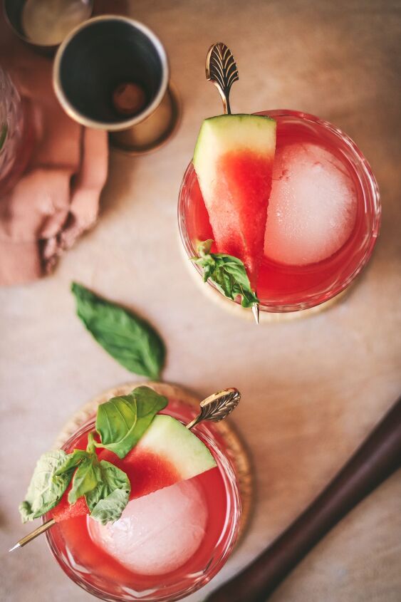 fresh watermelon vodka cocktail with basil, Two watermelon drinks with ice basil and watermelon wedges