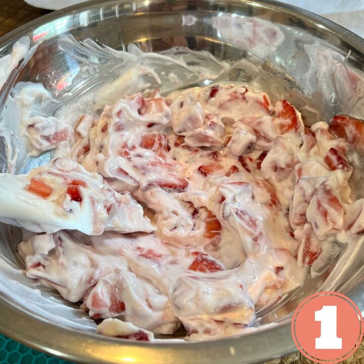 easy frozen yogurt chocolate strawberry bites, Yogurt and chopped strawberries in a stainless steel bowl