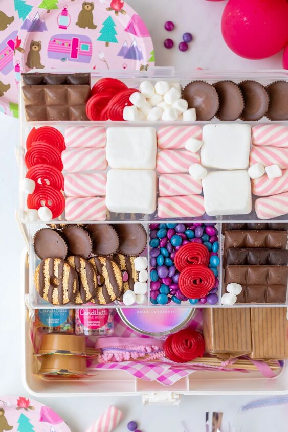 make the most of summer with a s mores snackle box, up close over the top view of a smores filled tackle box with marshmallows graham crackers cookies and a variety of chocolates