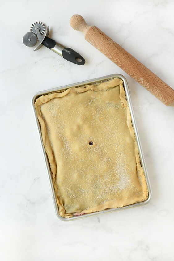 cherry blueberry slab pie a crowd pleasing dessert, Pie crust in a sheet pan with a pastry cutter and rolling pin