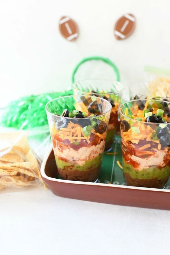 7 layer game day individual dip cups, 7 layer dip in small cups in a football tray
