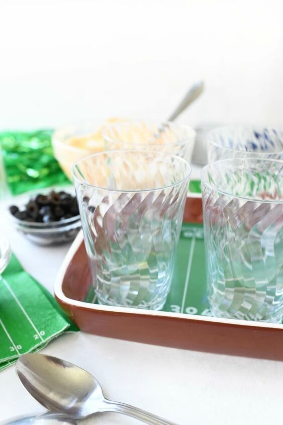 7 layer game day individual dip cups, 10 ounce clear cups on a football tray