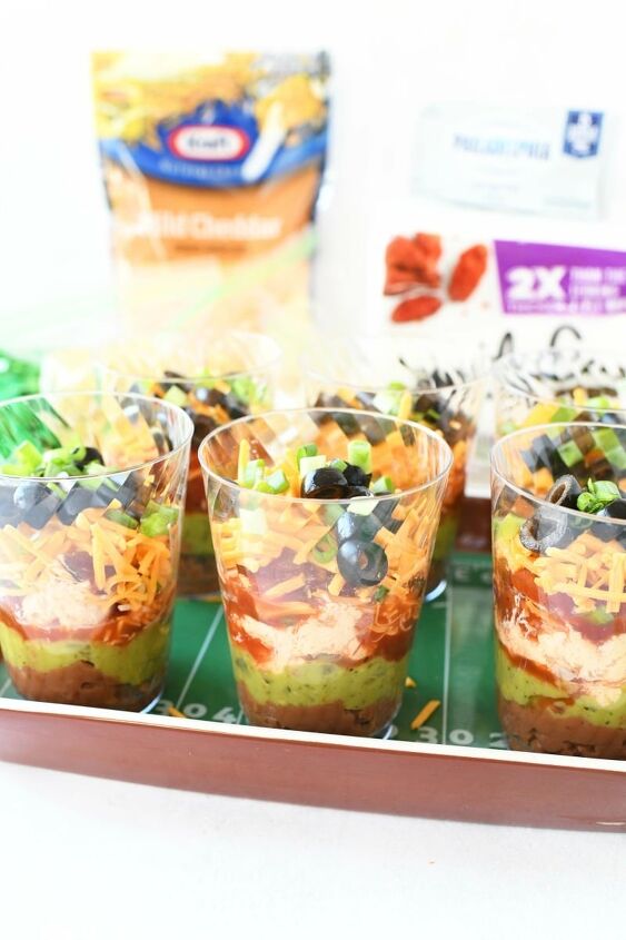 7 layer game day individual dip cups, 7 layer dip cups filled on a football tray